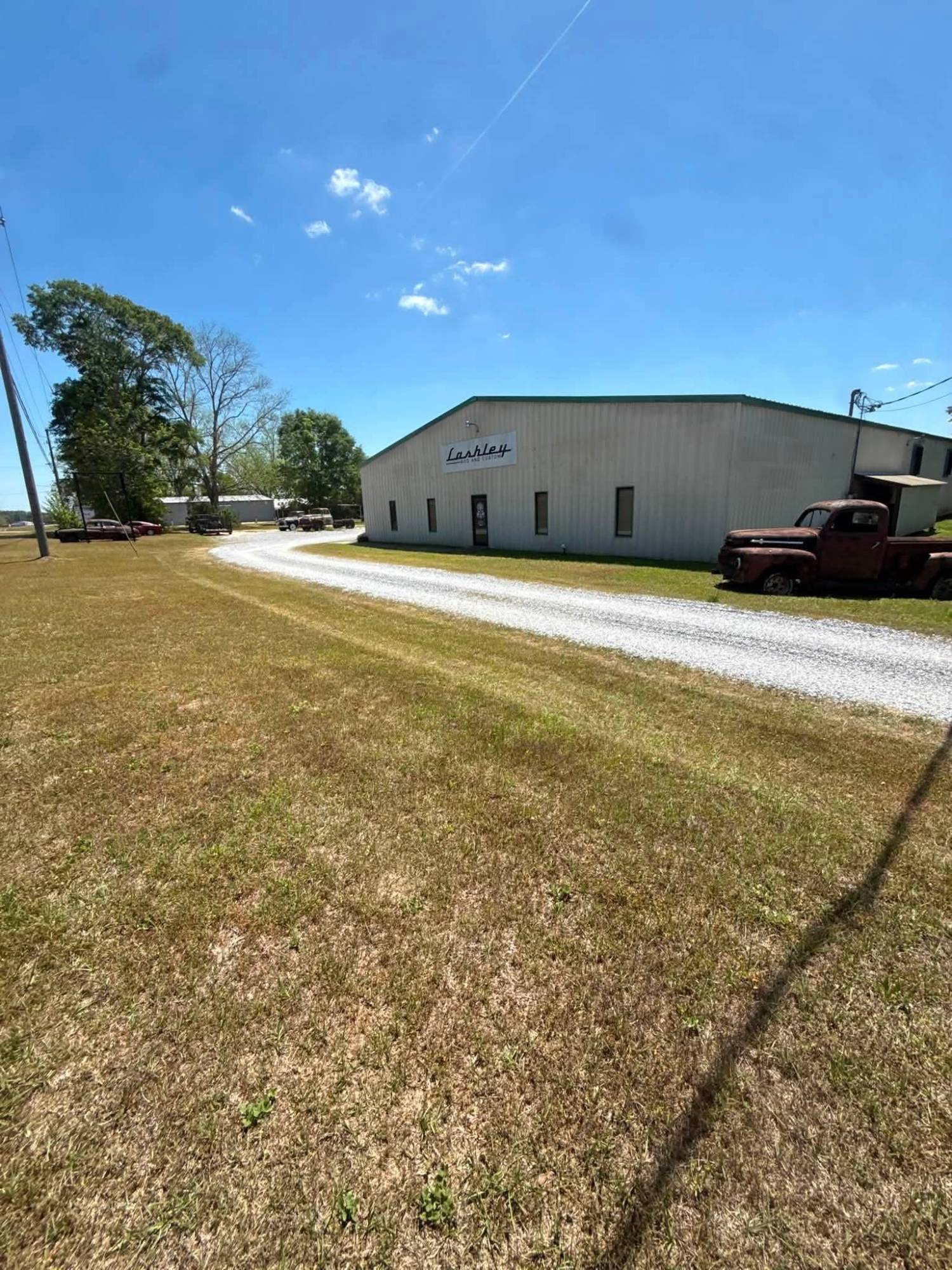 Commercial building with a gravel drive and freshly cut grass